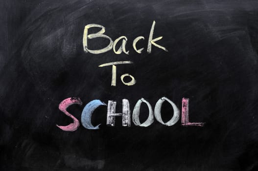 Chalkboard Background with a handwriting of "back to school"