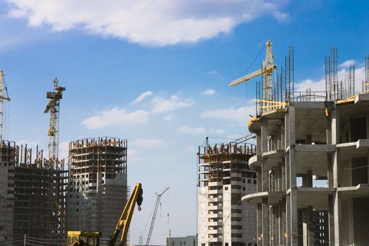 Kind on building construction on a background of the blue sky