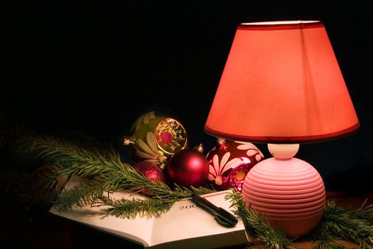 Desk lamp, christmas-tree decorations and notebook 