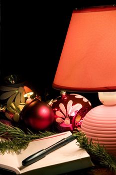 Desk lamp, christmas-tree decorations and notebook 