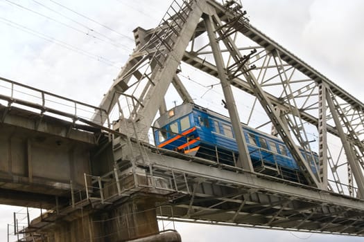 Diesel locomotive going on the railway bridge