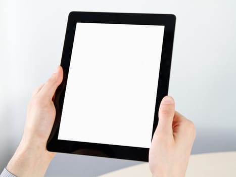 Man hands holding electronic tablet pc with blank screen.