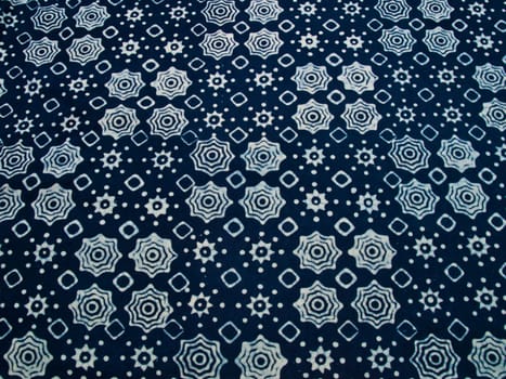 Blue batik fabric with repettition pattern as background from Yogyakarta, Indonesia