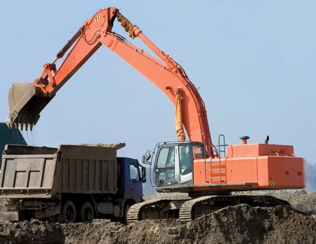 Dredge and the lorry on a background of the blue sky