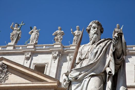 Statues in St. Peter Square (Rome, Italy) with blue sky background