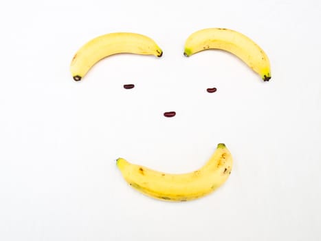 Smiling face made from banana and kidney bean