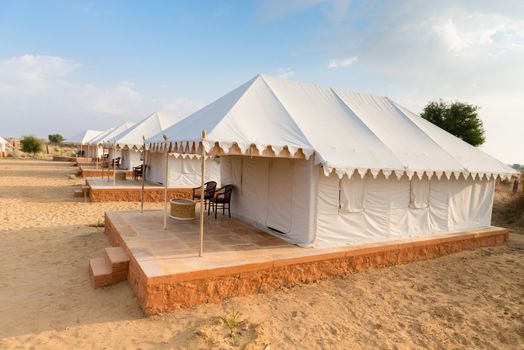 Tent camping site hotel for tourist  in the thar desert under blue sky