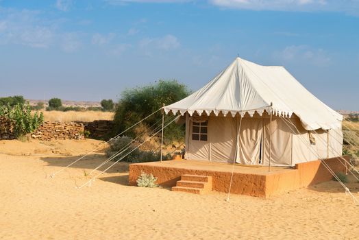 Tent in camping site hotel for tourist  in the thar desert under blue sky