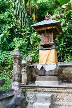 Traditional Balinese house of spirits with tropical forest on background