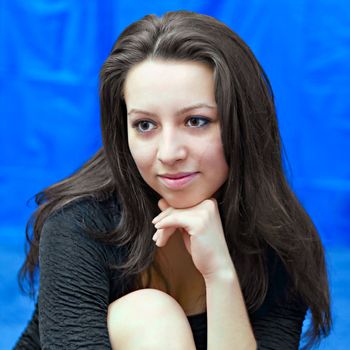 portrait of a young girl on  blue background