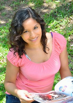 Young brunette lady reading a magazine