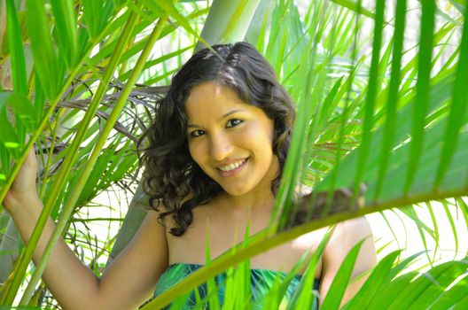 Brunette among the green palm fronds