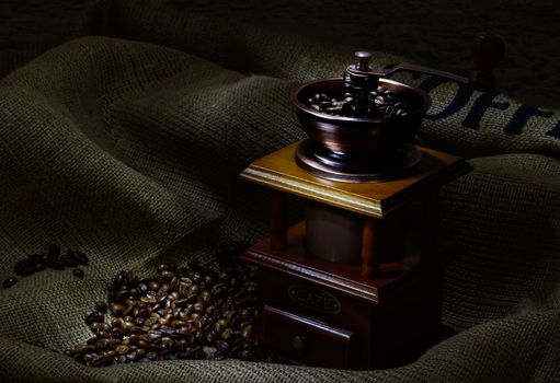 Coffee Mill with beans and burlap. still life