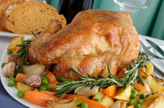 Baked chicken with vegetables and whole rosemary