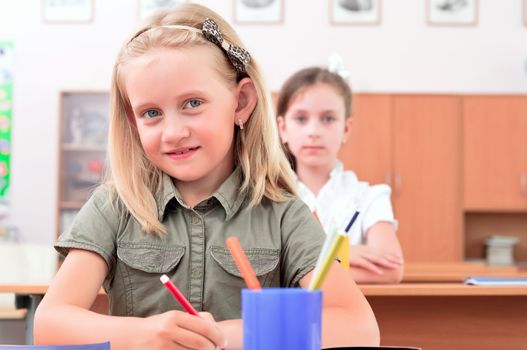 portrait of students in the classroom, sit at school desks