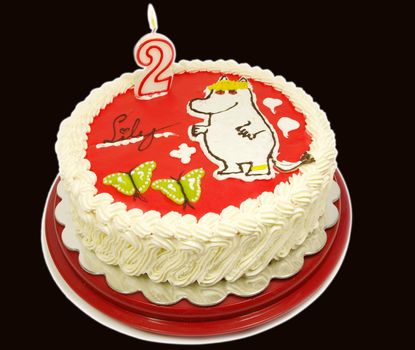 The Snork Maiden moomin, onto a cream cake, candle of number 2 with flame.