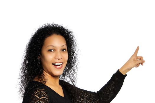 Surprised African American woman in pointing up gesture