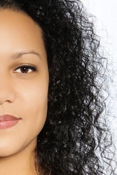 Half faced portrait of a beautiful girl with balck curly hair