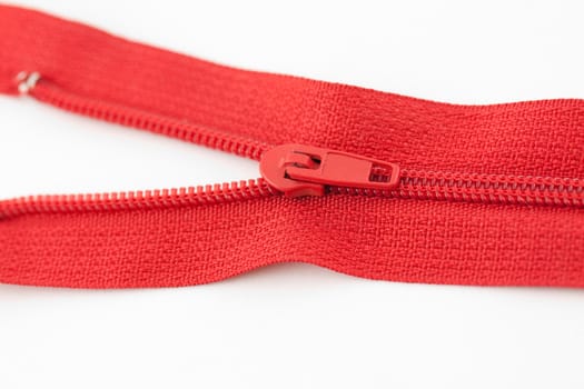 Red zipper starting to open on white background
