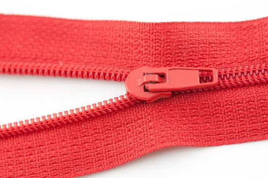 Open red zipper on a white background