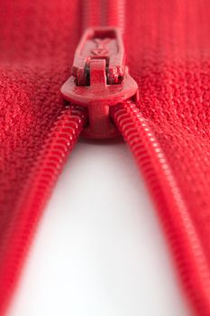 Open red zipper on a white background