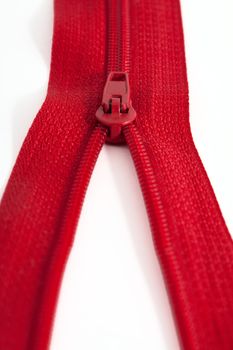 Open red zipper on a white background