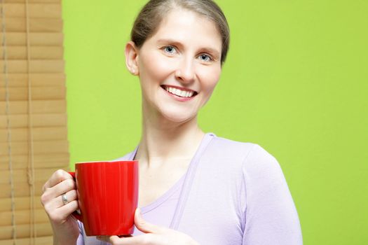Pretty mid aged woman with red cup of coffee