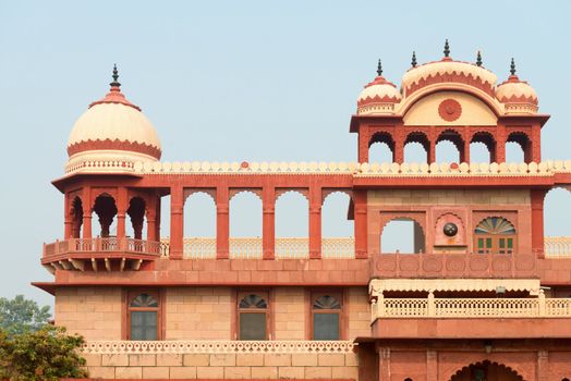 Building exterior in classical widespread indian style with arches, towers and balcony