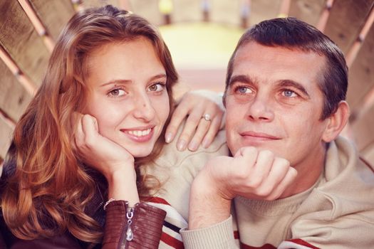 couple stand side by side and looking at the camera