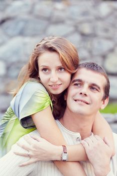 couple stand side by side and looking at the camera