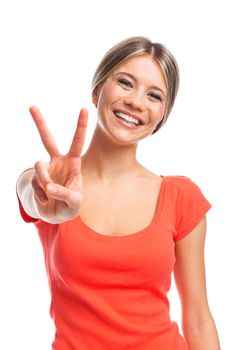 Young woman showing two fingers, positive or peace gesture, on white