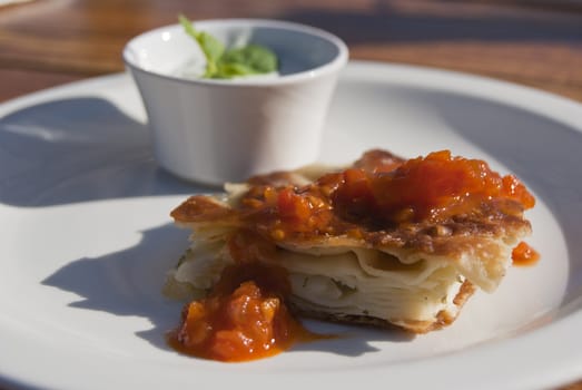 Puff pastry with sauce on the plate. Light snack.