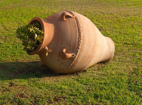 Greek ancient amphora on the lawn closeup