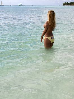 Beautiful woman in bikini sunbathing in the sea in blue lagoon