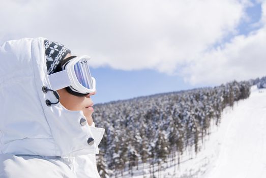 Portrait of beautiful skier looking forward on the route in Sarikamis