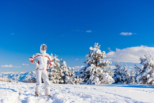 Serious beautiful skier on the top of mountain