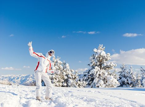 Happy beautiful skier on the top of mountain