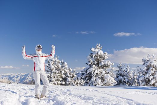 Success skier with confidence on the top of mountain