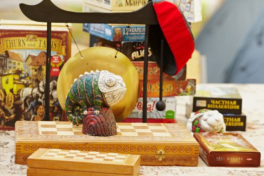 Lying on a table board games and figurine of chameleon