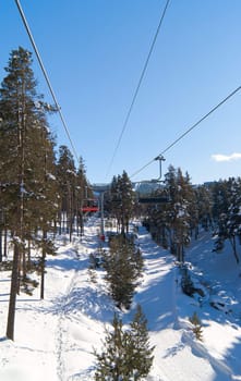 Chairlift in winter forest in sunny day. Sarikamis