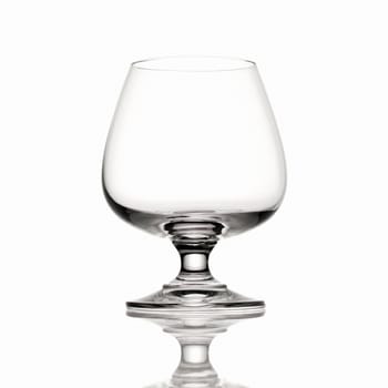 Empty Brandy glass on white background and reflection