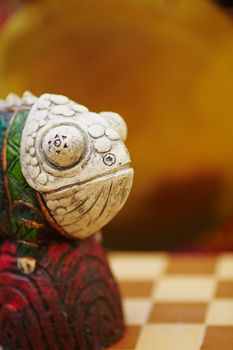 Figurine of chameleon on a chess-board. CU