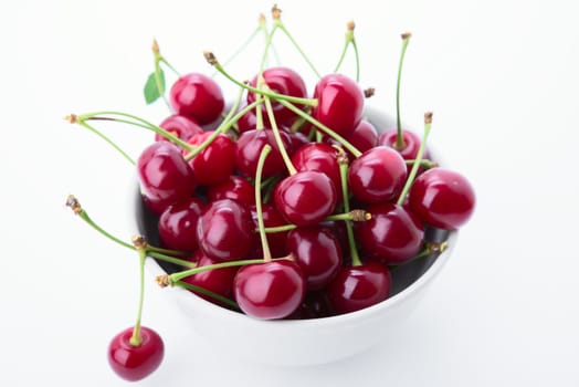 cherry is in a cup. On white background