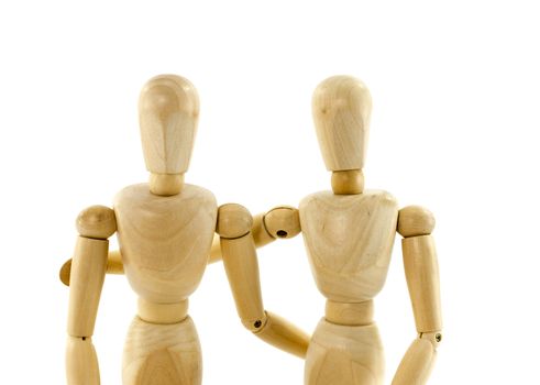 wooden puppets as couple with arms around