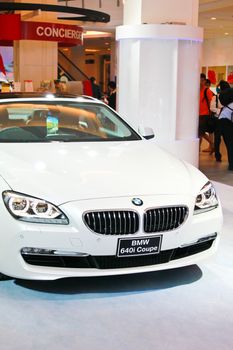 BANGKOK, THAILAND - DECEMBER 21: A luxury white model car,BMW 640i, was shown in central world department store on December 21, 2011 in Bangkok, Thailand