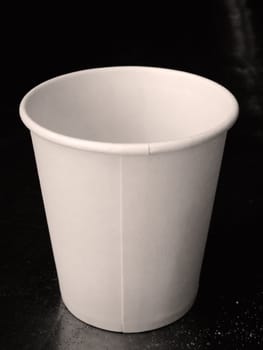 Front of White Paper cup on Black table