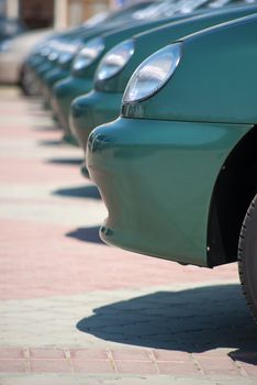 Row of brand new cars at a car dealership.