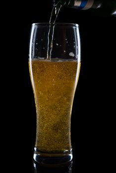 Fresh beer with froth and condensed water pearls on white  background