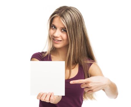 Smiling young woman showing a white card, on white