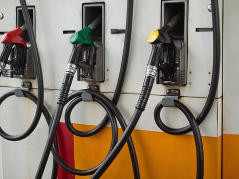 Three Gas Pump Nozzles at Gas Station Ready to work